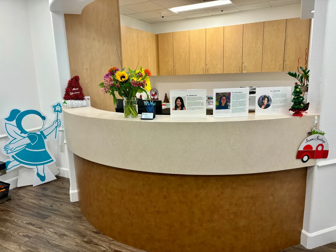 The Brentwood front desk decorated with flowers and family photos