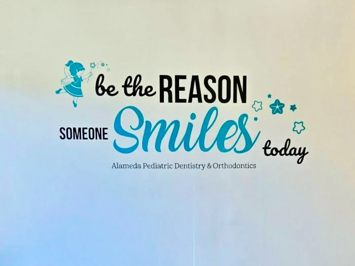 A wall reading "Be the reason someone smiles today" inside the Brentwood office