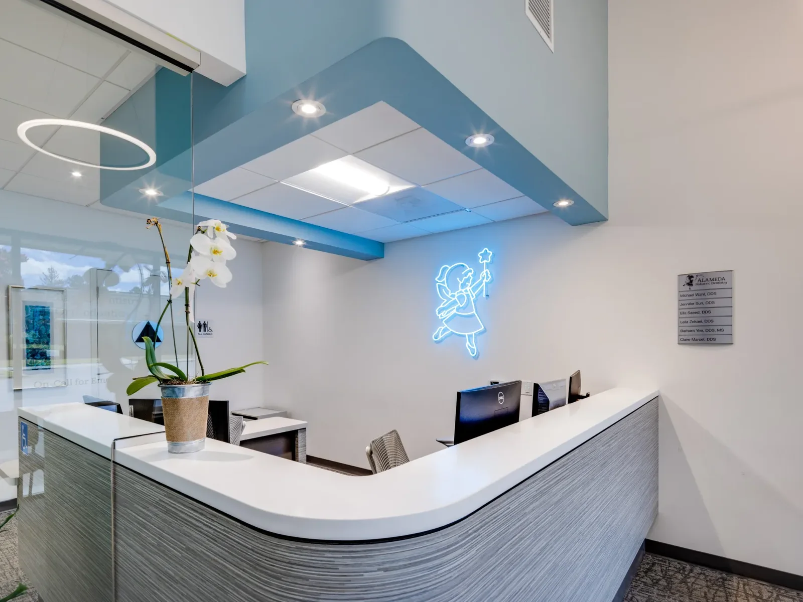 The Pleasanton front desk beneath the practice's neon mascot sign