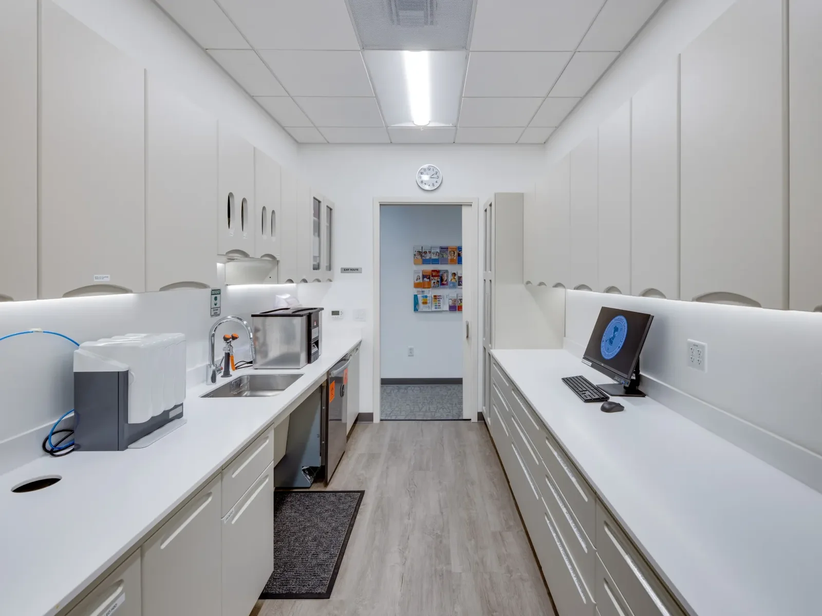 A hallway lined with treatment bays at the Pleasanton office