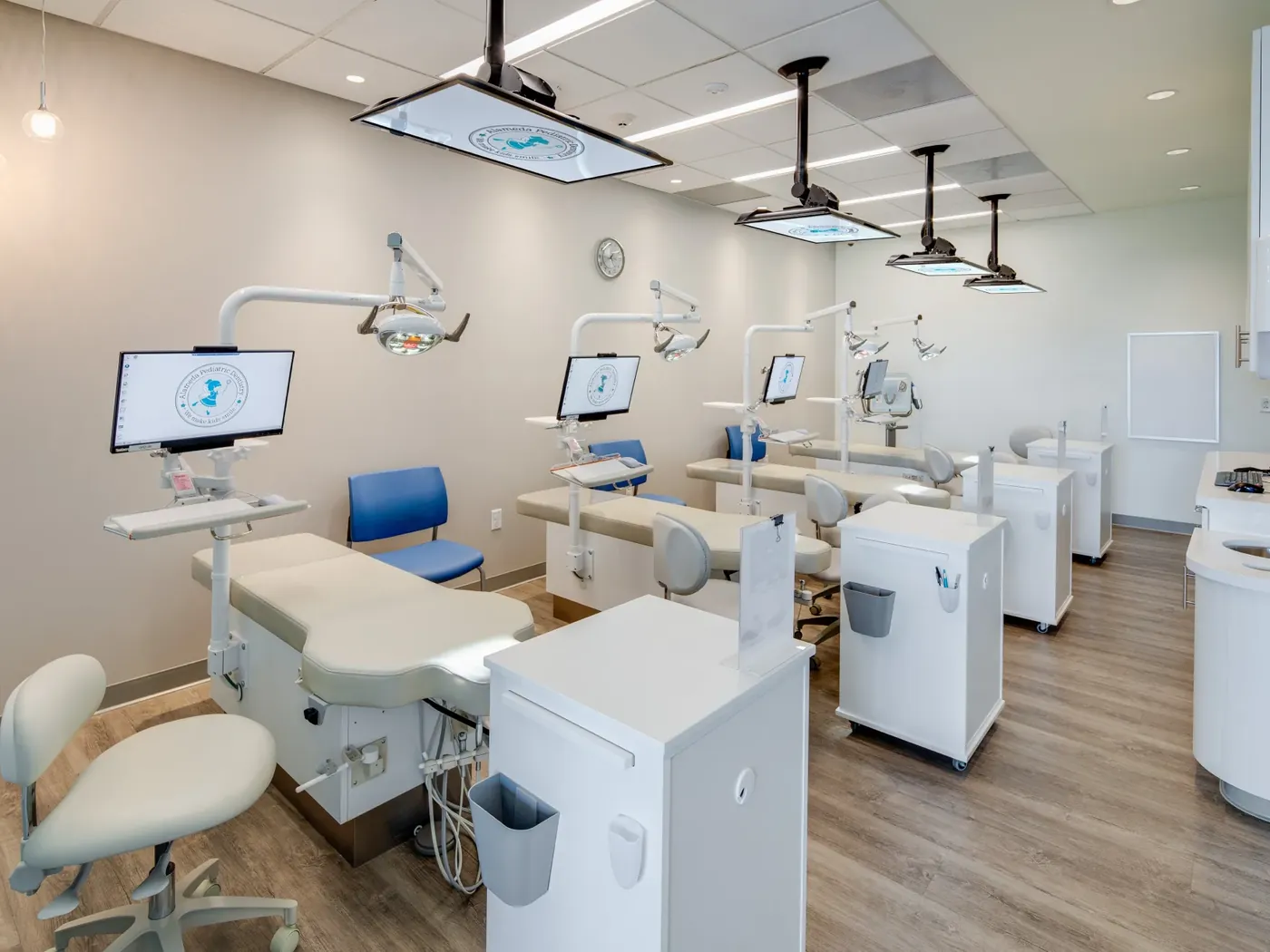 An open row of treatment bays set up for pediatric dental visits
