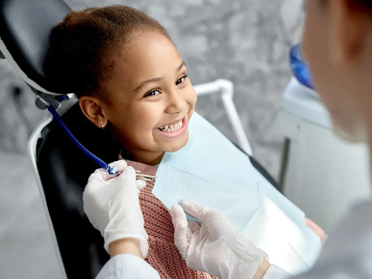 A young patient smiling during a dental visit