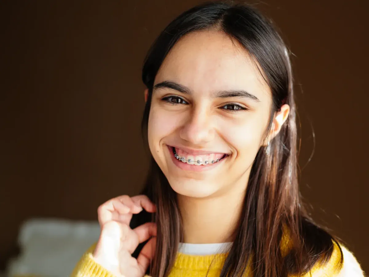 A teenage patient with braces smiling