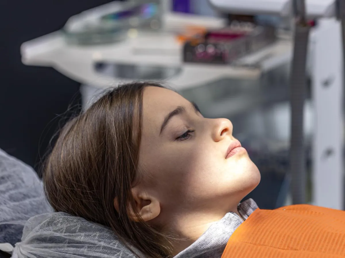 A child resting calmly in the dental chair during a sedation appointment