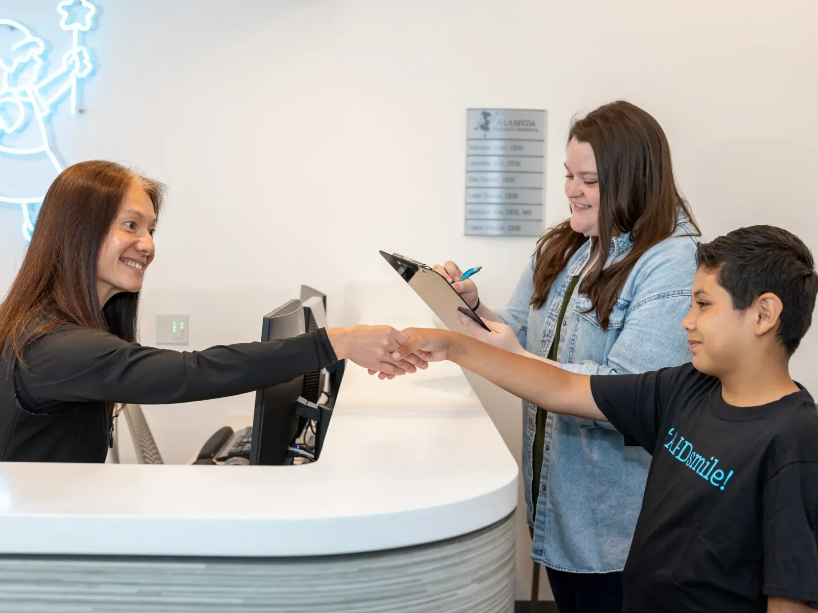 A patient checking in at the front desk